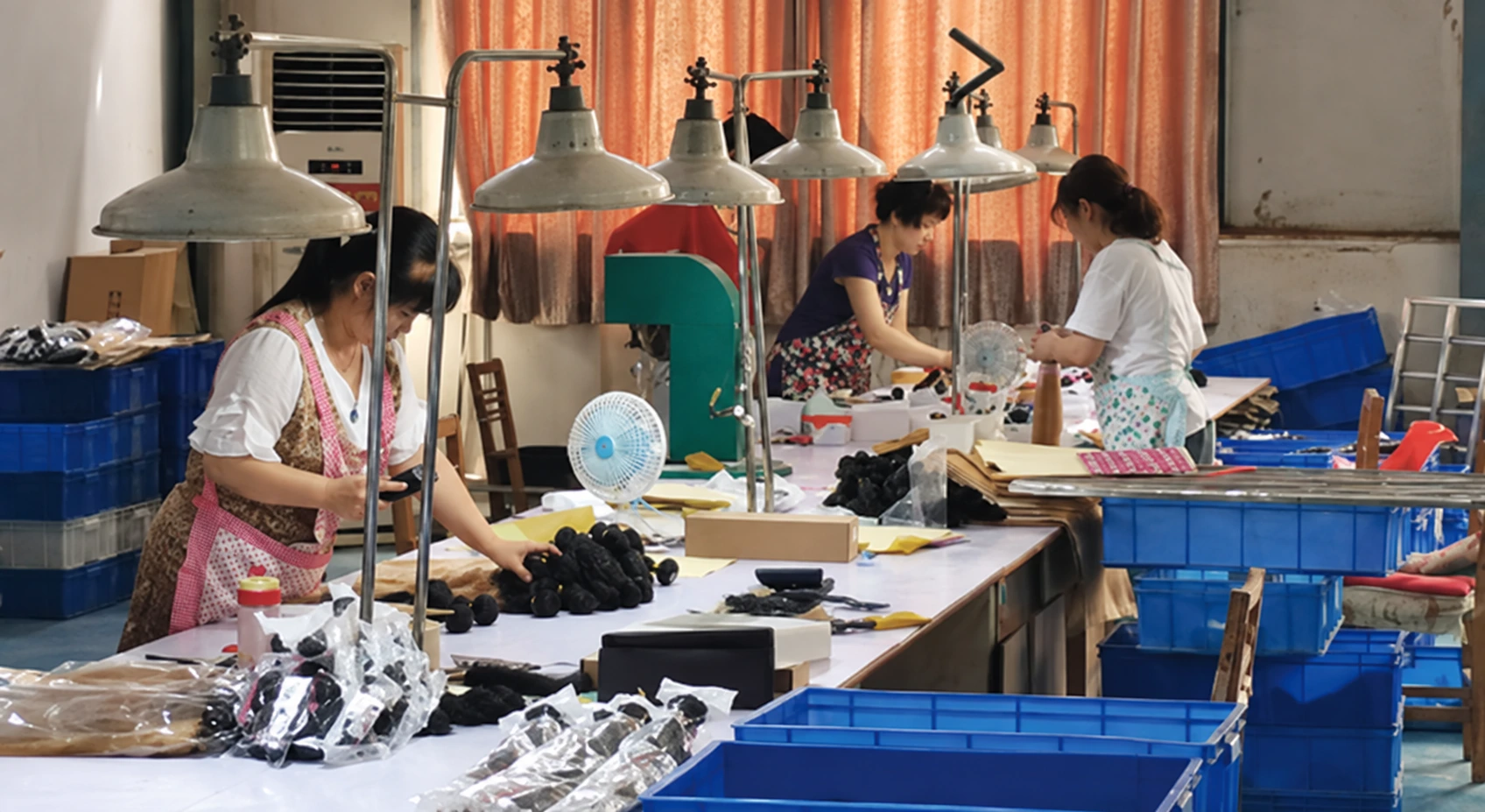 NUSFACE staff handling hair materials at individual workstations