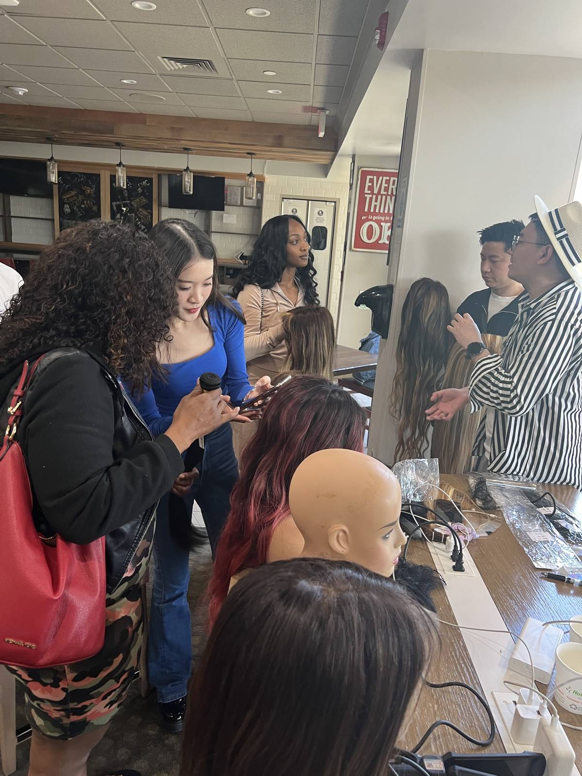 salon professionals reviewing finished balayage wigs during a US market visit