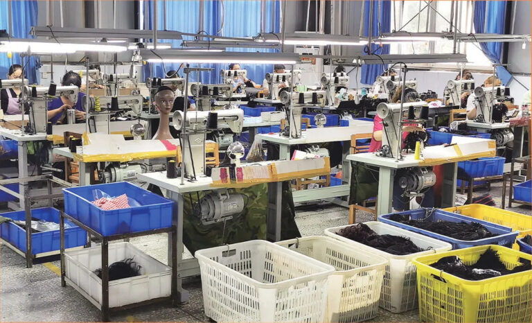 workers producing hand-painted balayage wigs at NUSFACE factory