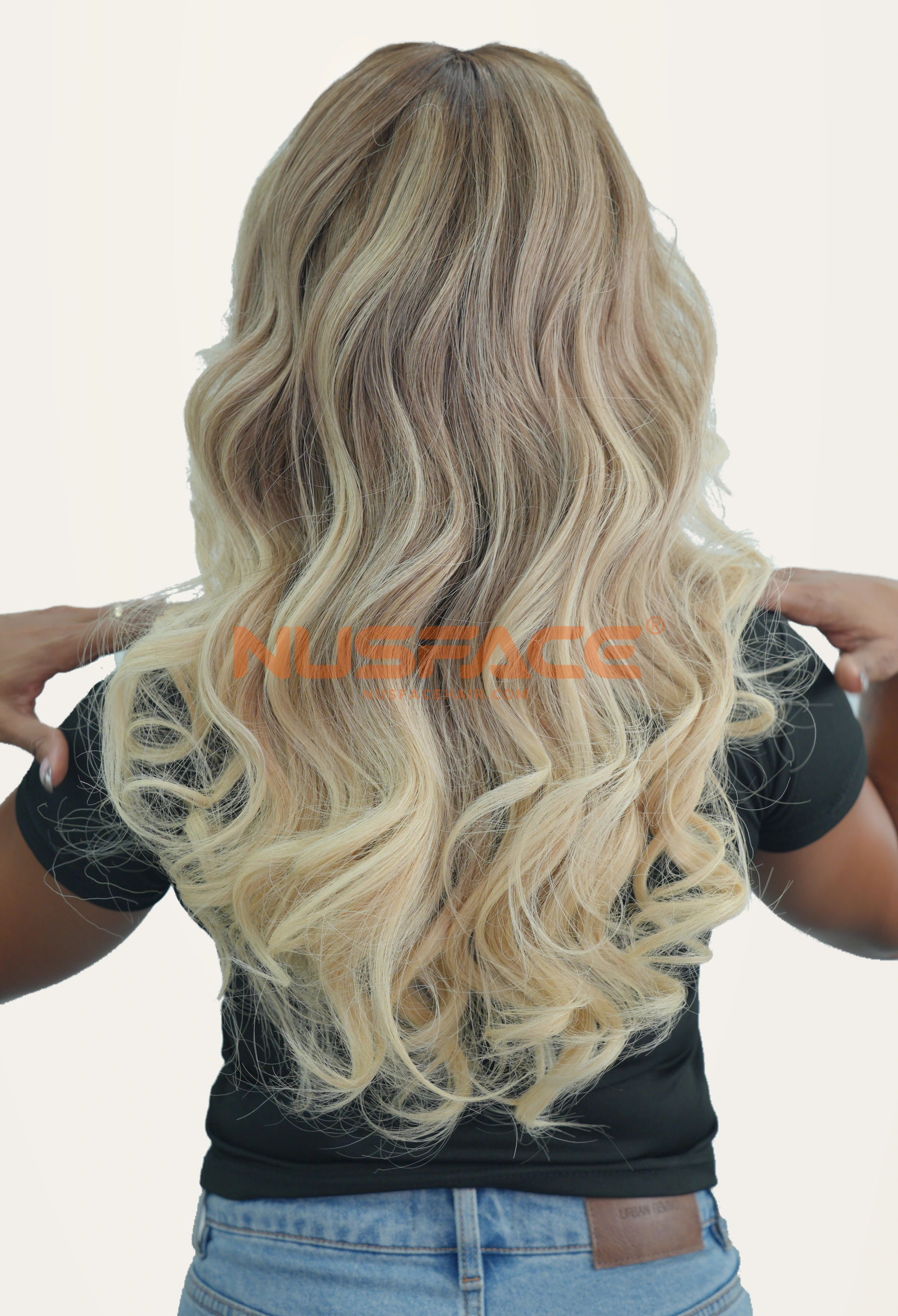 Back view of a NUSFACE blonde balayage human hair wig with darker roots and loose waves