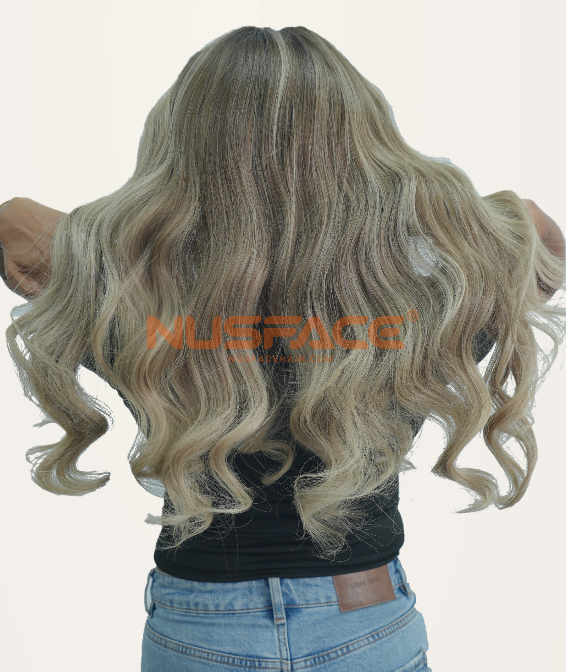 Back view of a NUSFACE ash-toned balayage wig with muted blonde waves and darker sections